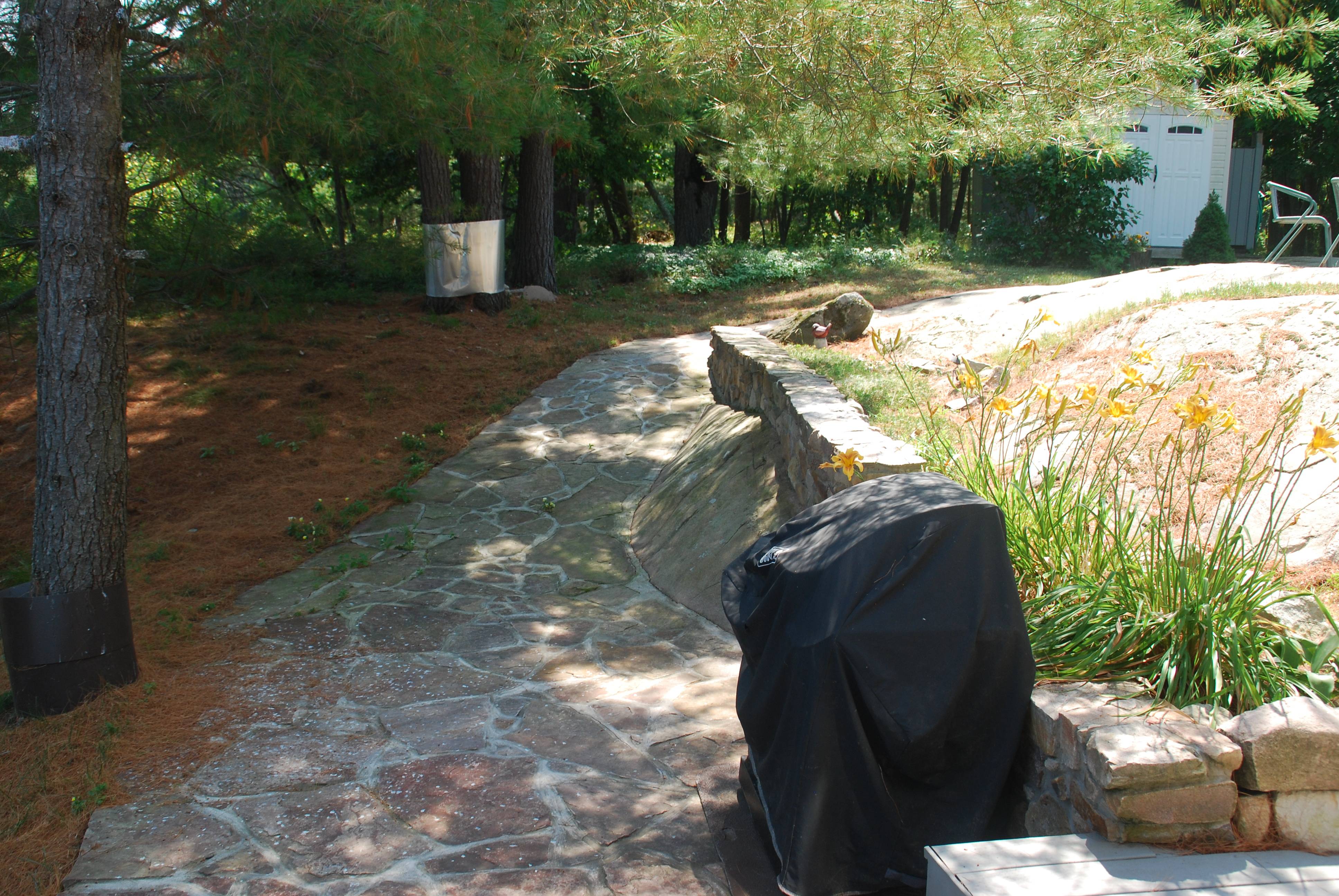 Stone path leading up to fire pit and outdoor shower